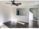 Spacious living room with wood floors, a ceiling fan, and a staircase leading to the upper level at 395 Wyndham Place Dr, Fuquay Varina, NC 27526