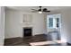 Cozy living room features a fireplace, wood floors, and lots of natural light at 395 Wyndham Place Dr, Fuquay Varina, NC 27526