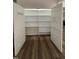 Spacious walk-in pantry with abundant shelving and organized door storage for ultimate kitchen convenience at 395 Wyndham Place Dr, Fuquay Varina, NC 27526