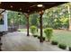 Well-lit covered patio that overlooks the backyard and mature trees at 395 Wyndham Place Dr, Fuquay Varina, NC 27526