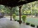 Relaxing covered patio overlooking a sprawling backyard and lush trees at 395 Wyndham Place Dr, Fuquay Varina, NC 27526