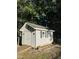 Charming backyard shed with a ramp, windows with shutters, and decorative accents at 395 Wyndham Place Dr, Fuquay Varina, NC 27526