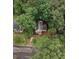 Aerial view of a home surrounded by lush trees, a driveway, and landscaping at 4009 Olde Coach Rd, Durham, NC 27707