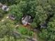 Aerial shot showcases a charming home nestled amid green trees, highlighting its attractive curb appeal at 4009 Olde Coach Rd, Durham, NC 27707