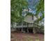 Exterior of home showcasing backyard, deck and mature trees at 4009 Olde Coach Rd, Durham, NC 27707