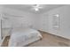 Spacious bedroom features a white bed, carpet, and natural light at 4009 Olde Coach Rd, Durham, NC 27707