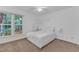 Bright bedroom with a queen-sized bed, carpet, and natural light at 4009 Olde Coach Rd, Durham, NC 27707