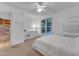 Well-lit bedroom with carpet, dresser, and a large window overlooking trees at 4009 Olde Coach Rd, Durham, NC 27707