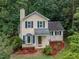 Charming two-story home with a landscaped yard, bay window, and mature trees at 4009 Olde Coach Rd, Durham, NC 27707