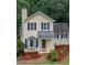 Charming two-story home with manicured landscaping, featuring a bay window and inviting front porch at 4009 Olde Coach Rd, Durham, NC 27707