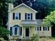 Charming two-story home with manicured landscaping, featuring a bay window and inviting front porch at 4009 Olde Coach Rd, Durham, NC 27707