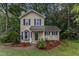 Charming two-story home with mature trees, well-maintained landscaping, and inviting curb appeal at 4009 Olde Coach Rd, Durham, NC 27707