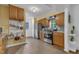 Well-lit kitchen with wooden cabinets and stainless steel appliances at 4009 Olde Coach Rd, Durham, NC 27707