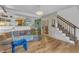 Open living room with hardwood floors, connecting to kitchen, dining area, and staircase at 4009 Olde Coach Rd, Durham, NC 27707