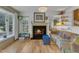 Bright living room featuring a cozy fireplace, natural light, and hardwood floors at 4009 Olde Coach Rd, Durham, NC 27707