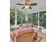 Bright sunroom with many windows and ceiling fan, perfect for enjoying the outdoors at 4009 Olde Coach Rd, Durham, NC 27707