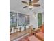 Bright sunroom with many windows and ceiling fan, perfect for enjoying the outdoors at 4009 Olde Coach Rd, Durham, NC 27707