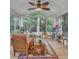 Bright sunroom with many windows and ceiling fan, perfect for enjoying the outdoors at 4009 Olde Coach Rd, Durham, NC 27707