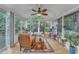 Inviting sunroom bathed in natural light, surrounded by scenic views and cozy seating at 4009 Olde Coach Rd, Durham, NC 27707