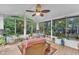 Bright sunroom with expansive windows offering serene views of the surrounding greenery at 4009 Olde Coach Rd, Durham, NC 27707