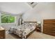 Cozy bedroom featuring a large window with natural light, neutral carpet, and comfortable furnishings at 4645 Edwards Mill Rd, Raleigh, NC 27612