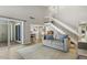 Open-concept living area with soaring ceilings, staircase, and a seamless flow to the dining area at 4645 Edwards Mill Rd, Raleigh, NC 27612