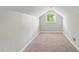 Cozy finished attic space with neutral carpet and a window providing natural light at 4905 Knightsbridge Way, Raleigh, NC 27604