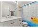 Bathroom with a white vanity, mirror and a shower with a fun ducky shower curtain at 4905 Knightsbridge Way, Raleigh, NC 27604
