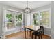 Bright dining area with wood floors and large windows showcasing the front yard at 4905 Knightsbridge Way, Raleigh, NC 27604