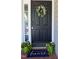Charming home features a black front door adorned with a wreath and welcome mat at 4905 Knightsbridge Way, Raleigh, NC 27604