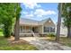 Charming single-story home featuring a welcoming front porch and a well-maintained front yard at 4905 Knightsbridge Way, Raleigh, NC 27604
