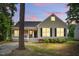 Charming single Gathering home featuring a cozy front porch with lights shining from the windows at twilight at 4905 Knightsbridge Way, Raleigh, NC 27604