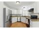Bright, updated kitchen with stainless steel appliances, white cabinets, and granite countertops at 4905 Knightsbridge Way, Raleigh, NC 27604