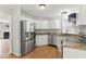Bright kitchen featuring stainless appliances, modern cabinetry and granite countertops at 4905 Knightsbridge Way, Raleigh, NC 27604