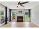 Bright living room with fireplace, hardwood floors, and large windows at 4905 Knightsbridge Way, Raleigh, NC 27604