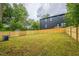 Large grassy backyard with a wooden fence, providing a private and spacious outdoor area at 507 N Elm St, Durham, NC 27701