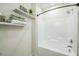 Close-up of bathtub/shower combo in a bathroom with marble floating shelves at 507 N Elm St, Durham, NC 27701