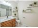 Bright bathroom with a vanity, shower-tub combo, and decorative floating shelves at 507 N Elm St, Durham, NC 27701