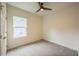 This bright bedroom features plush carpeting, a ceiling fan, and a large window at 507 N Elm St, Durham, NC 27701