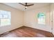 Bedroom with wood floors, ceiling fan and two windows at 507 N Elm St, Durham, NC 27701