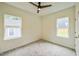 This cozy bedroom features plush carpeting, a ceiling fan, and great natural light from two windows at 507 N Elm St, Durham, NC 27701