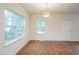 Bright living room with wood floors, large windows, and ample natural light, perfect for relaxing at 507 N Elm St, Durham, NC 27701