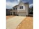 Charming two-story home with white siding, black shutters and a two car garage and long driveway at 516 Winding Creek Dr, Lillington, NC 27546