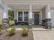 Inviting front porch with stone columns, offering a charming entrance to the home at 516 Winding Creek Dr, Lillington, NC 27546