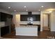 Open kitchen featuring stainless steel appliances, an island with sink, and dark cabinetry at 526 Catalina Grande Dr, Cary, NC 27519