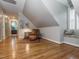 Comfortable sitting area in converted attic with sloped ceilings and hardwood floors at 5401 Fire Pink Way, Raleigh, NC 27613