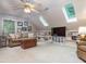 Finished attic room with built in shelving, TV, and carpet flooring at 5401 Fire Pink Way, Raleigh, NC 27613