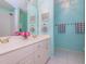 Bright bathroom with double sink vanity, tile flooring, and blue walls at 5401 Fire Pink Way, Raleigh, NC 27613