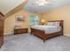 Comfortable bedroom featuring neutral carpet, a ceiling fan, and a wooden bed frame at 5401 Fire Pink Way, Raleigh, NC 27613