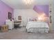 Bedroom with desk, white furniture, chandelier, and purple accent wall at 5401 Fire Pink Way, Raleigh, NC 27613